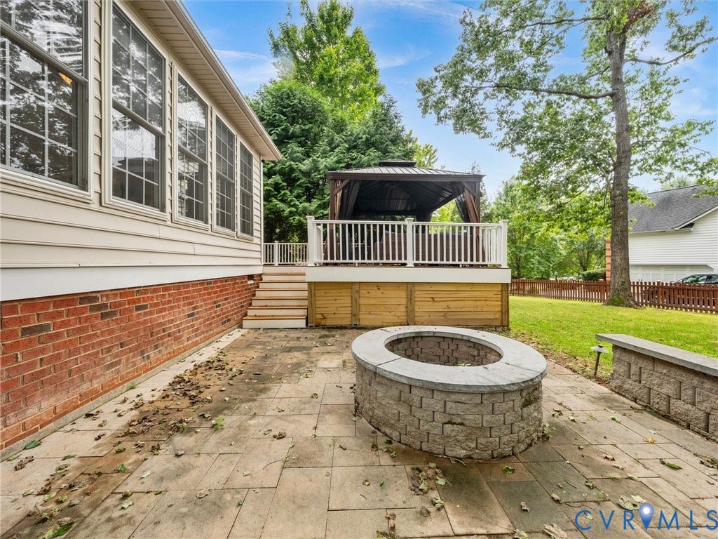 6100 Lilting Branch Way, Moseley, VA 23120 Expansive stone patio with a built-in fire pit