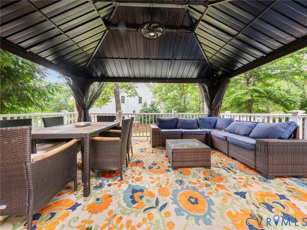 6100 Lilting Branch Way, Moseley, VA 23120 Covered outdoor deck featuring a metal gazebo, white railing, and a ceiling fan