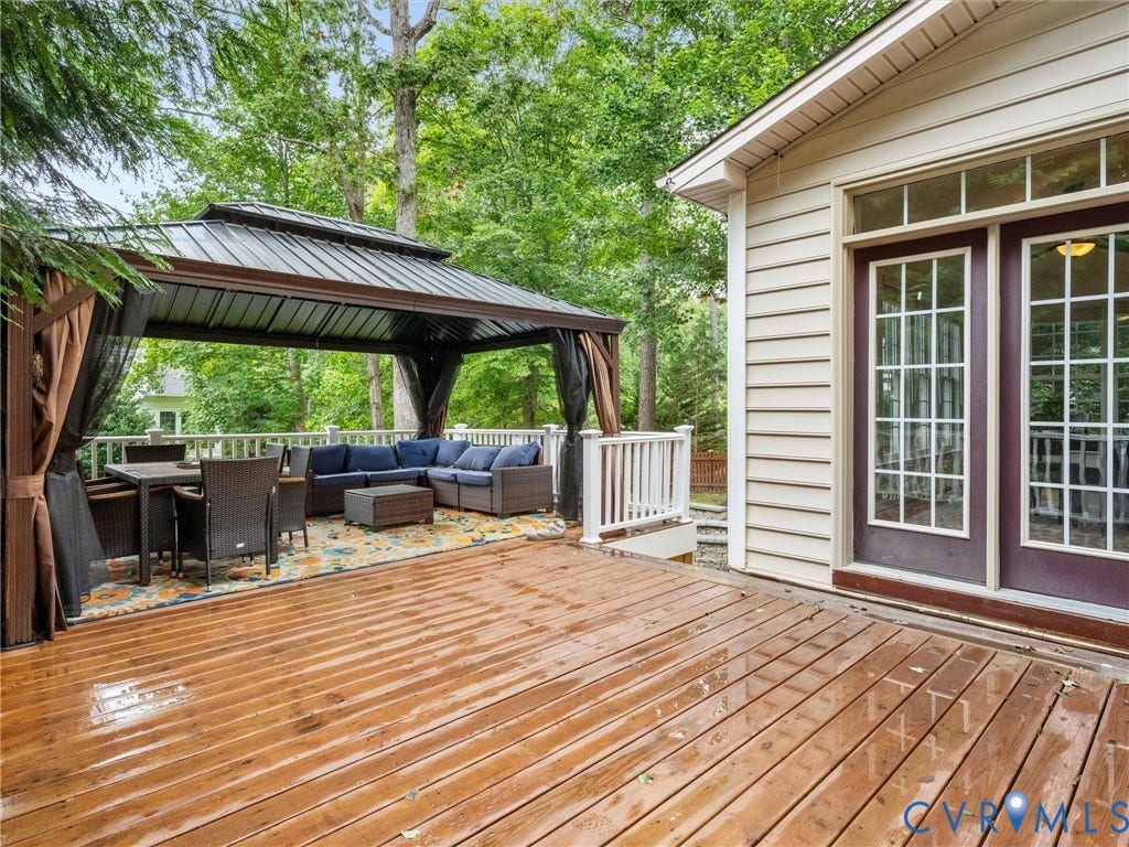 6100 Lilting Branch Way, Moseley, VA 23120 Expansive wood-finish deck with a built-in gazebo featuring a metal roof and privacy screens