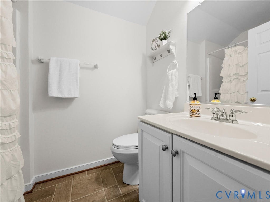6100 Lilting Branch Way, Moseley, VA 23120 White vanity with a single basin sink, chrome faucet, and integrated countertop