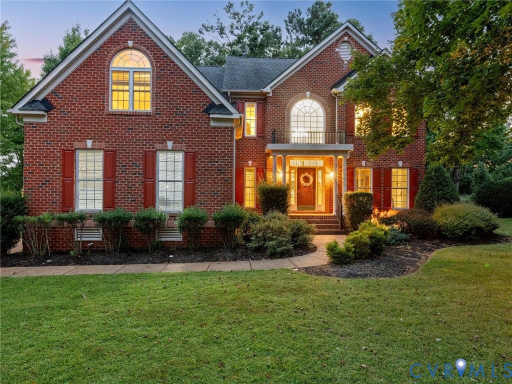 6100 Lilting Branch Way, Moseley, VA 23120 Brick exterior with a covered entry, arched windows, and landscaped grounds