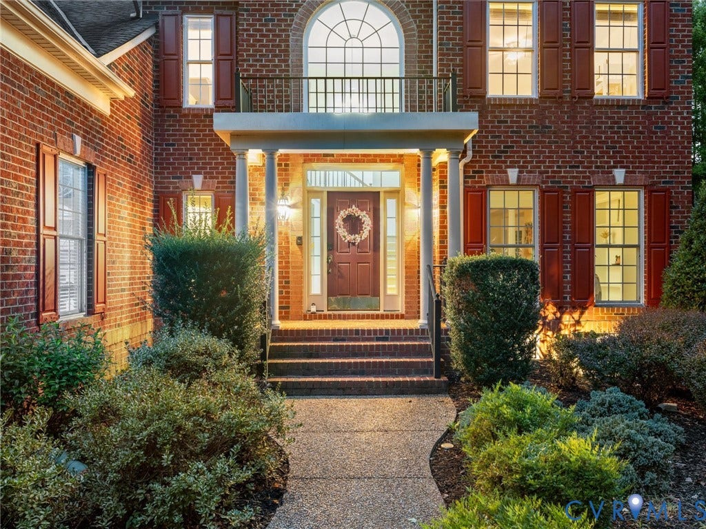 6100 Lilting Branch Way, Moseley, VA 23120 Brick exterior with a covered entry, arched window, and decorative shutters