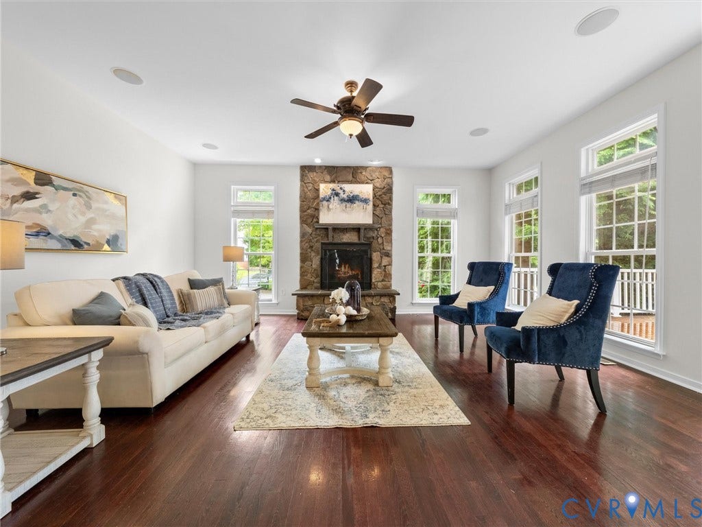 6100 Lilting Branch Way, Moseley, VA 23120 Hardwood flooring, stone-clad fireplace, recessed lighting, ceiling fan, and multiple windows
