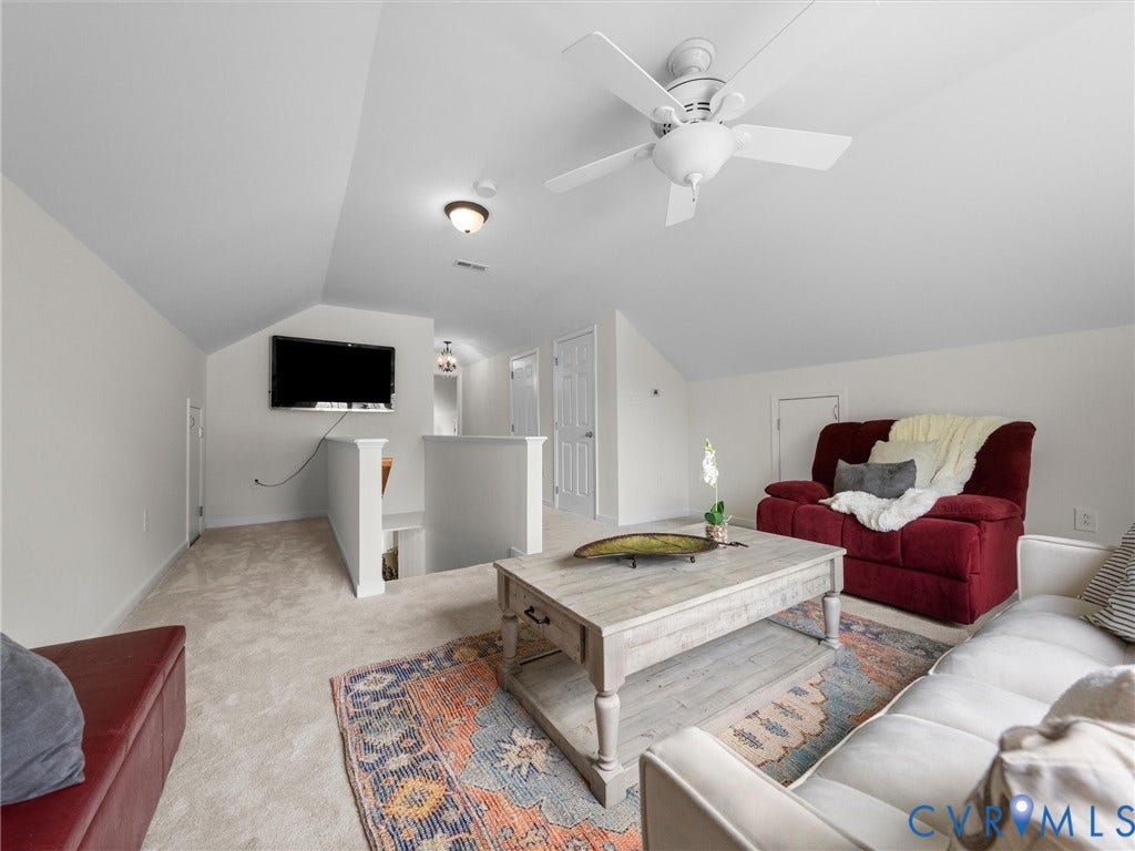 6100 Lilting Branch Way, Moseley, VA 23120 Carpeted loft area featuring a ceiling fan, sloped ceilings, and white painted walls
