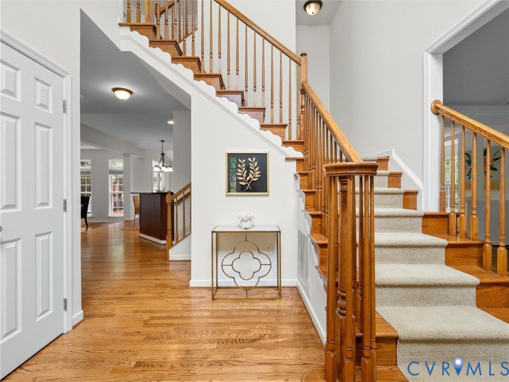 6100 Lilting Branch Way, Moseley, VA 23120 Hardwood flooring, white paneled door, wood staircase with carpet treads, wood banister with spindles, recessed lighting