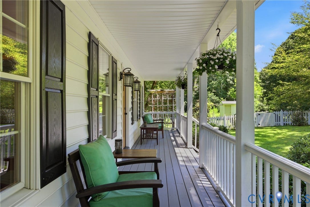 1915 Norwood Creek Drive, Powhatan, VA 23139 Expansive front porch featuring gray wood-finish flooring, white siding, black window shutters, and multiple exterior wall lanterns