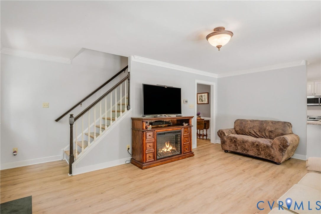 1915 Norwood Creek Drive, Powhatan, VA 23139 Living area featuring light wood-finish flooring and an integrated electric fireplace