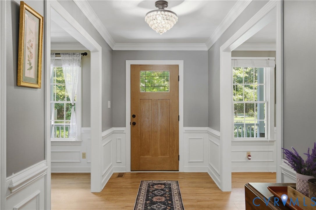 1915 Norwood Creek Drive, Powhatan, VA 23139 Entry foyer featuring a wood-finish door with glass inserts, hardwood flooring, wainscoting, and crown molding