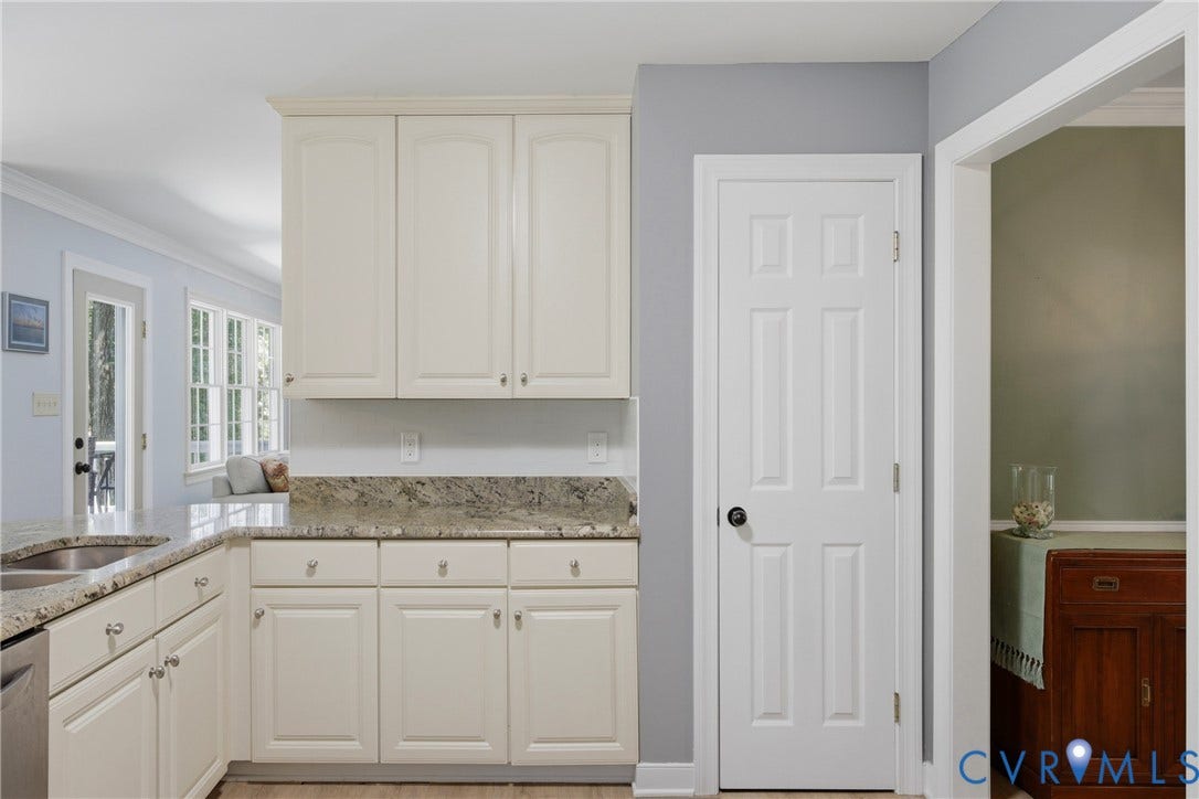 1915 Norwood Creek Drive, Powhatan, VA 23139 Kitchen featuring cream-colored cabinetry, stone-finish countertops, an undermount sink, and wood-finish flooring