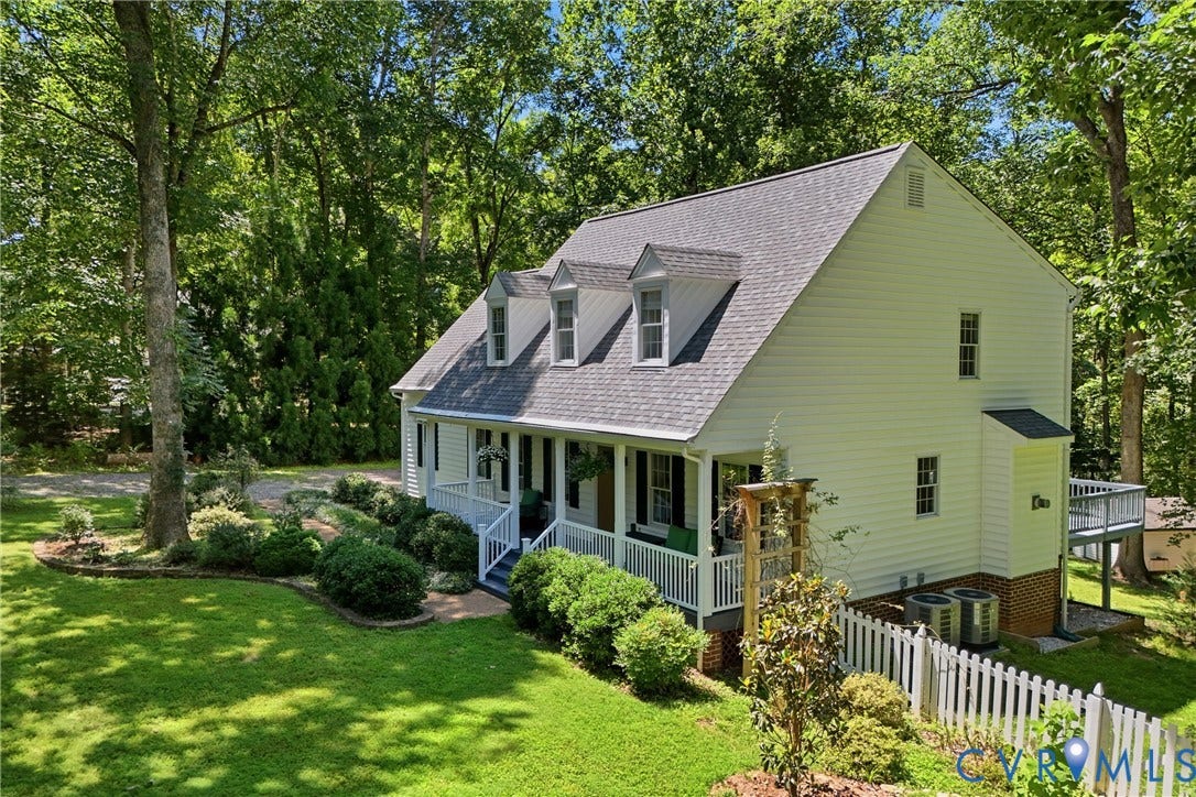1915 Norwood Creek Drive, Powhatan, VA 23139 White siding exterior with a dark shingle roof and three dormer windows