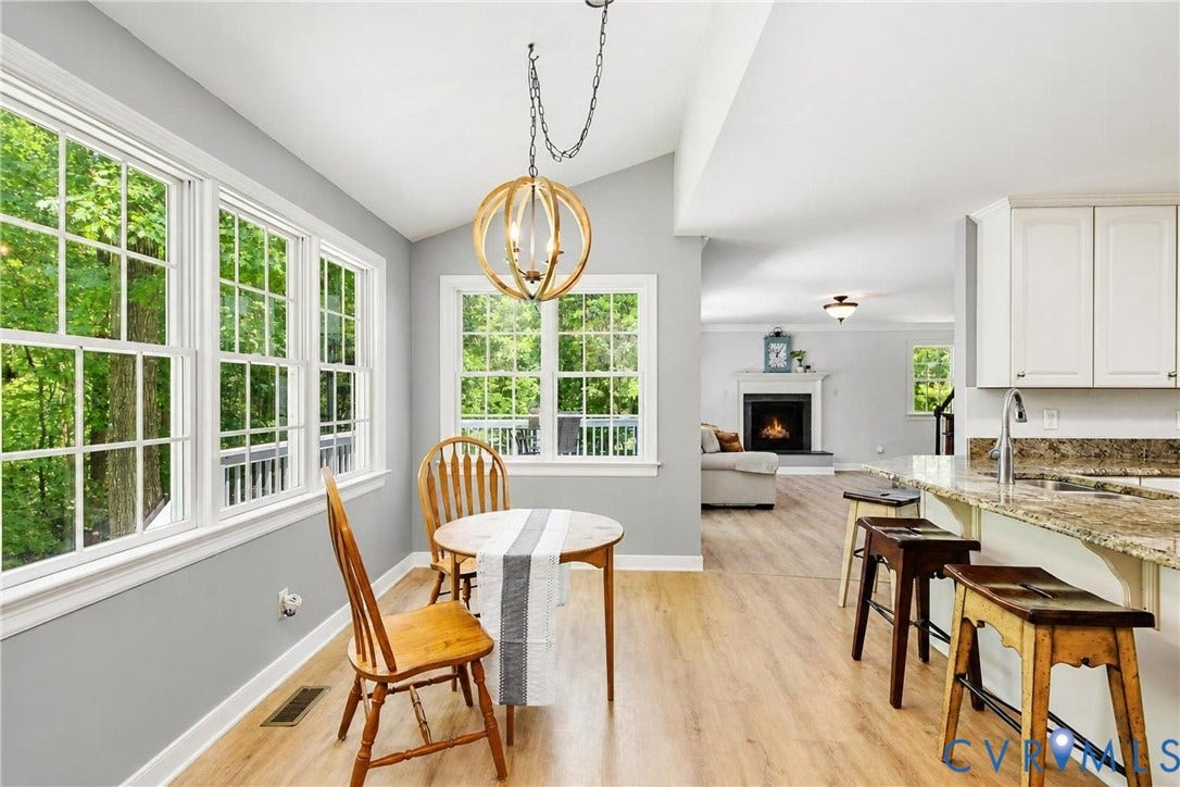 1915 Norwood Creek Drive, Powhatan, VA 23139 Bright dining area with vaulted ceilings, wood-finish flooring, and a contemporary chandelier