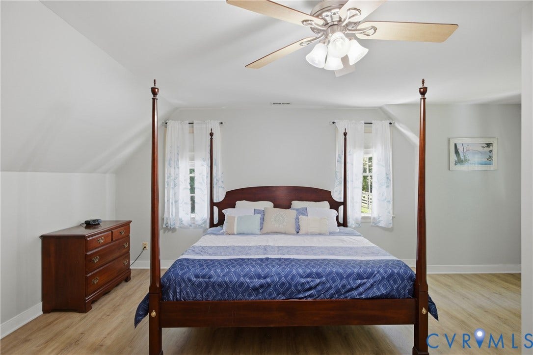 1915 Norwood Creek Drive, Powhatan, VA 23139 Room featuring wood-finish flooring, a ceiling fan with integrated lighting, and two windows with white trim