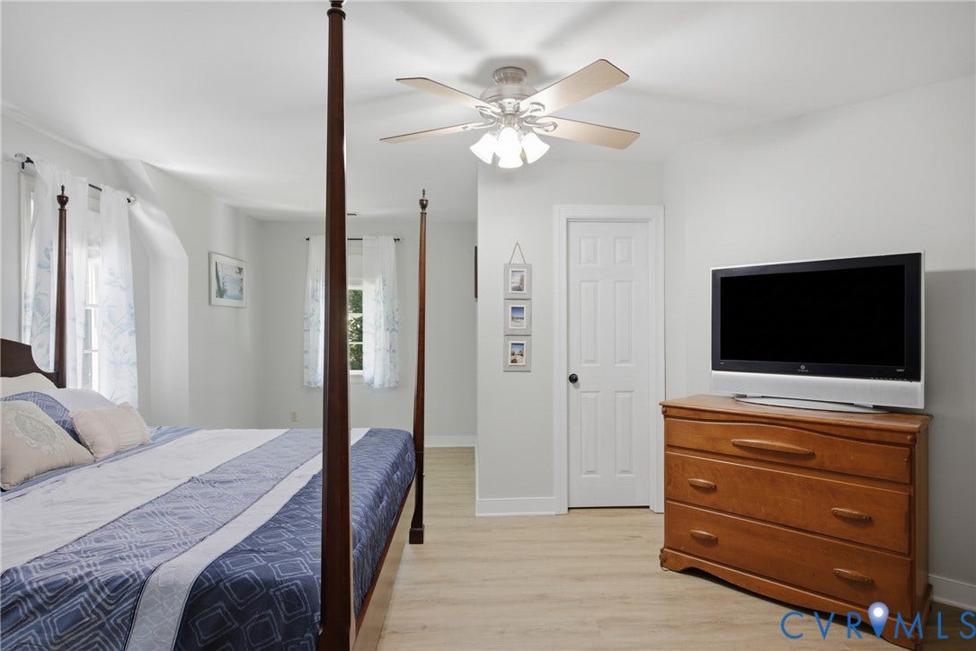 1915 Norwood Creek Drive, Powhatan, VA 23139 Bright interior featuring light-toned wood-finish flooring, a white five-panel door, and a ceiling fan with light fixture
