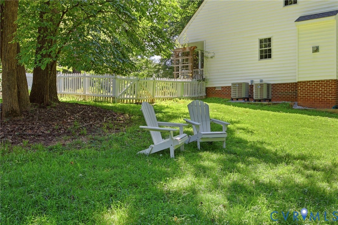 1915 Norwood Creek Drive, Powhatan, VA 23139 Expansive lawn featuring mature trees and a white picket fence