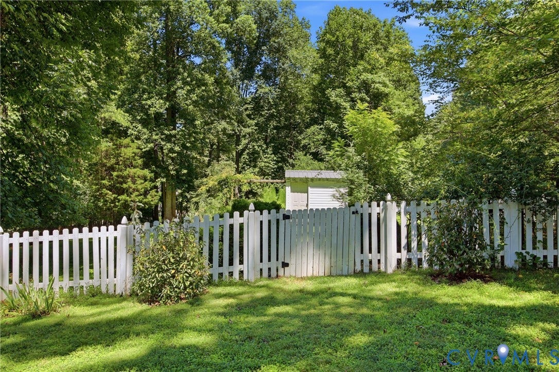 1915 Norwood Creek Drive, Powhatan, VA 23139 Expansive green lawn bounded by a white picket fence with a functional gate