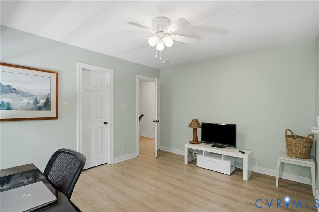 1915 Norwood Creek Drive, Powhatan, VA 23139 Bright interior space featuring light wood-finish flooring, a white ceiling fan, and white trim