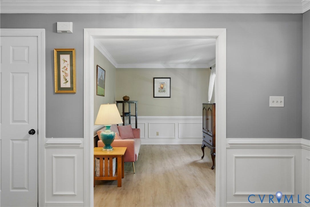 1915 Norwood Creek Drive, Powhatan, VA 23139 Light wood-finish flooring complements the wainscoting and crown molding throughout