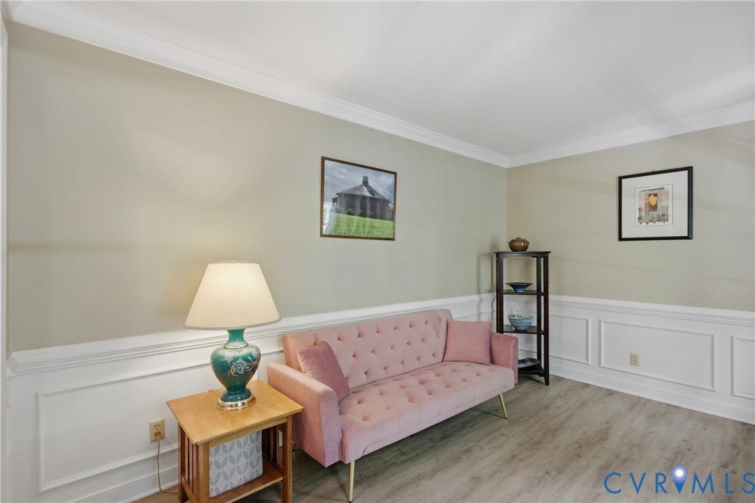 1915 Norwood Creek Drive, Powhatan, VA 23139 Room featuring light wood-finish flooring, wainscoting, crown molding, and neutral wall tones