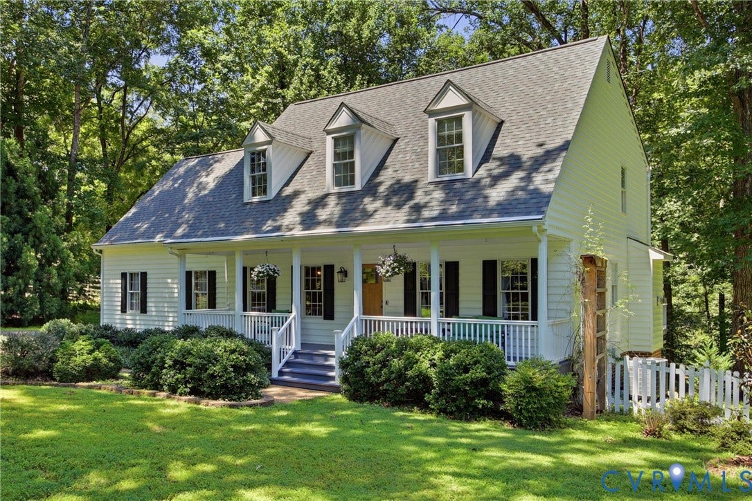 1915 Norwood Creek Drive, Powhatan, VA 23139 Cape Cod style residence featuring a prominent front porch, dormer windows, and a white picket fence
