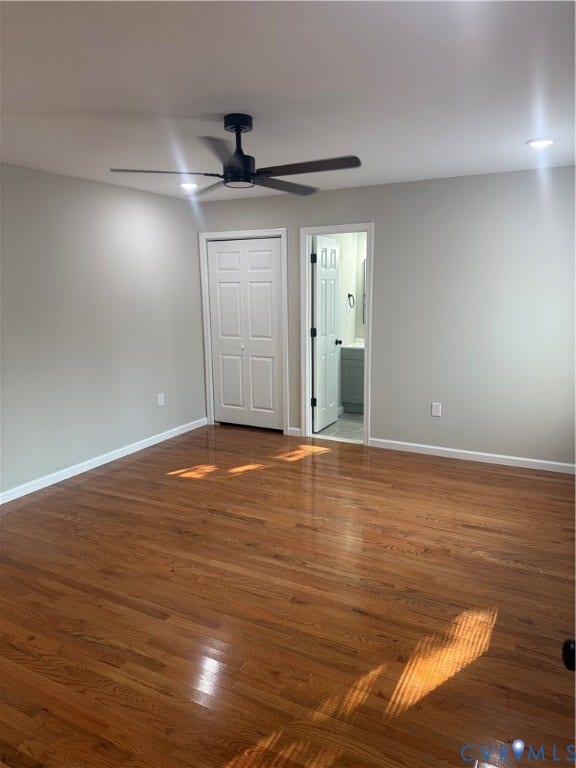 Hardwood flooring throughout featuring a modern ceiling fan with integrated lighting, recessed ceiling lights, and double closet doors