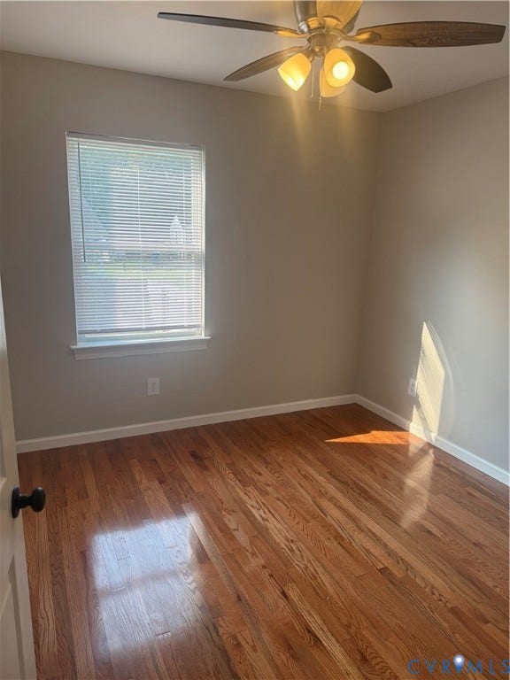 Room featuring wood-finish flooring, a window with blinds, and a ceiling fan with integrated lighting