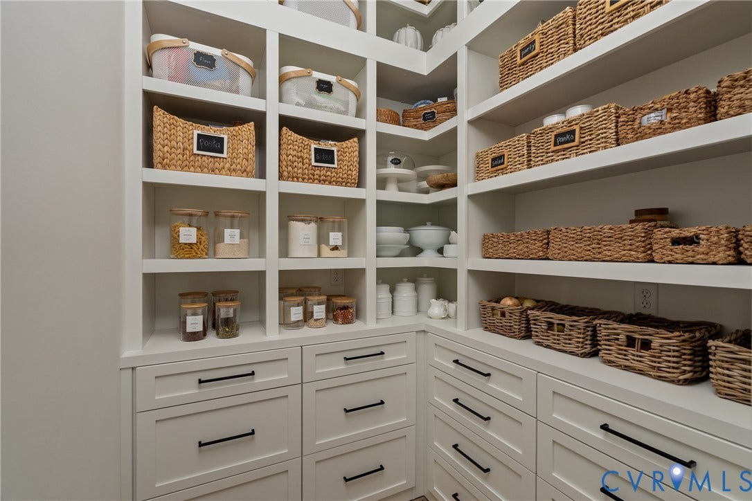 18312 Barrin Court, Barrington, Moseley, VA 23120 Custom pantry featuring white built-in shelving, integrated drawers with dark hardware, and ample storage capacity