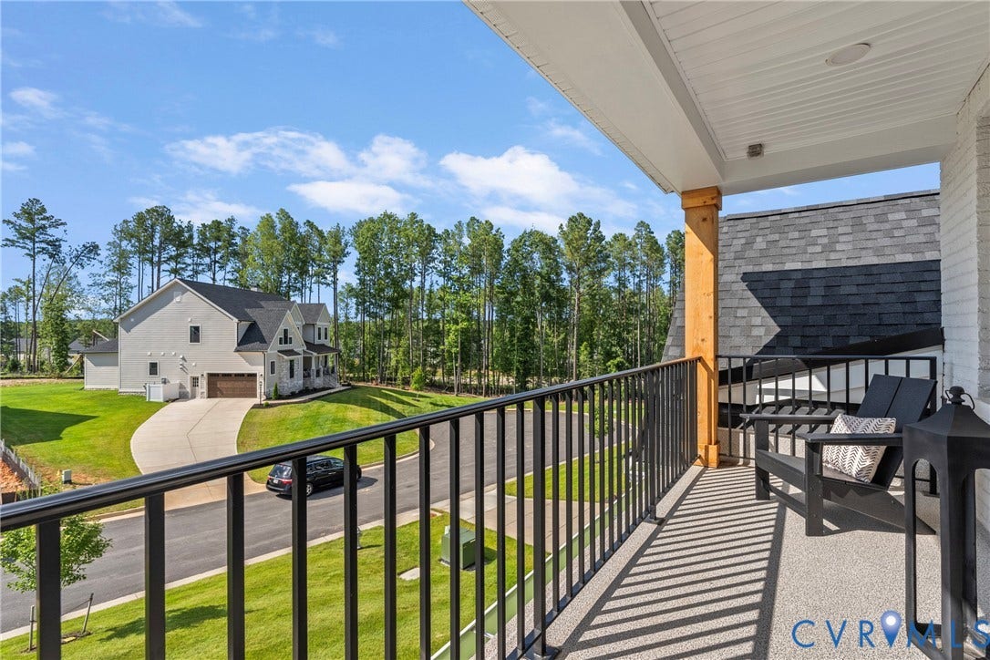 18312 Barrin Court, Barrington, Moseley, VA 23120 Balcony featuring a black metal railing, a natural wood support beam, and a textured floor