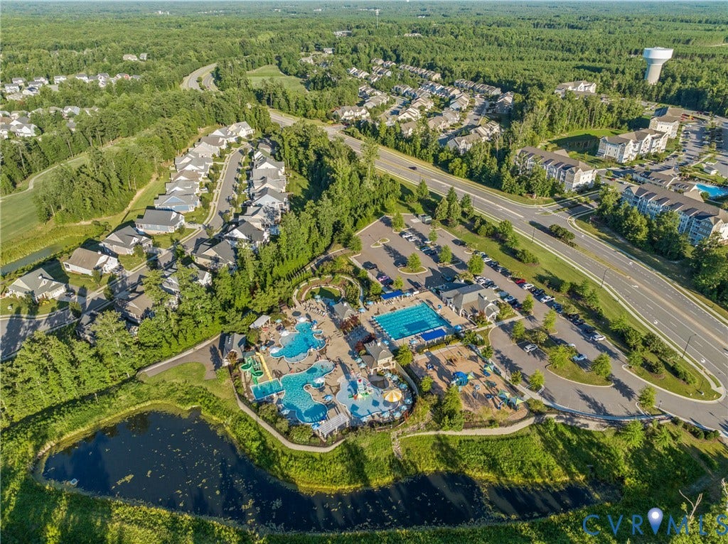 18312 Barrin Court, Barrington, Moseley, VA 23120 Expansive aquatic amenity featuring multiple pools, a water slide, and shaded lounge areas