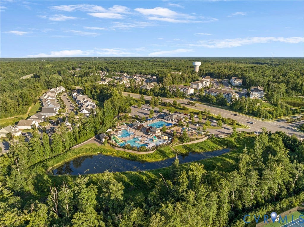 18312 Barrin Court, Barrington, Moseley, VA 23120 Community aerial showcasing a large aquatic complex with multiple pools and water slides, surrounded by lush green landscaping