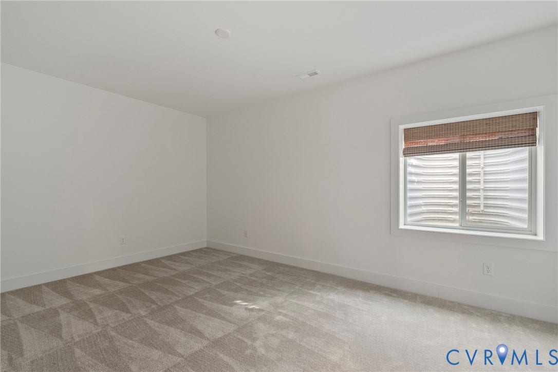 18312 Barrin Court, Barrington, Moseley, VA 23120 Room featuring patterned carpeting, white walls, a recessed ceiling light, and a window with a woven shade