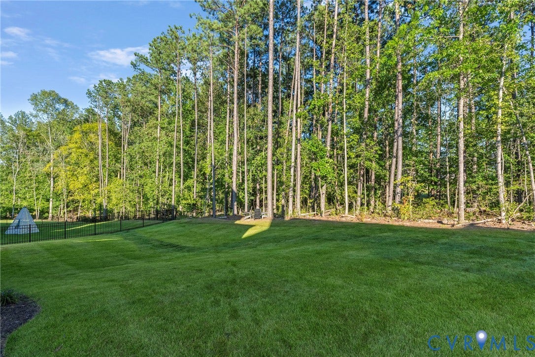 18312 Barrin Court, Barrington, Moseley, VA 23120 Expansive green lawn bordered by a black metal fence and mature trees