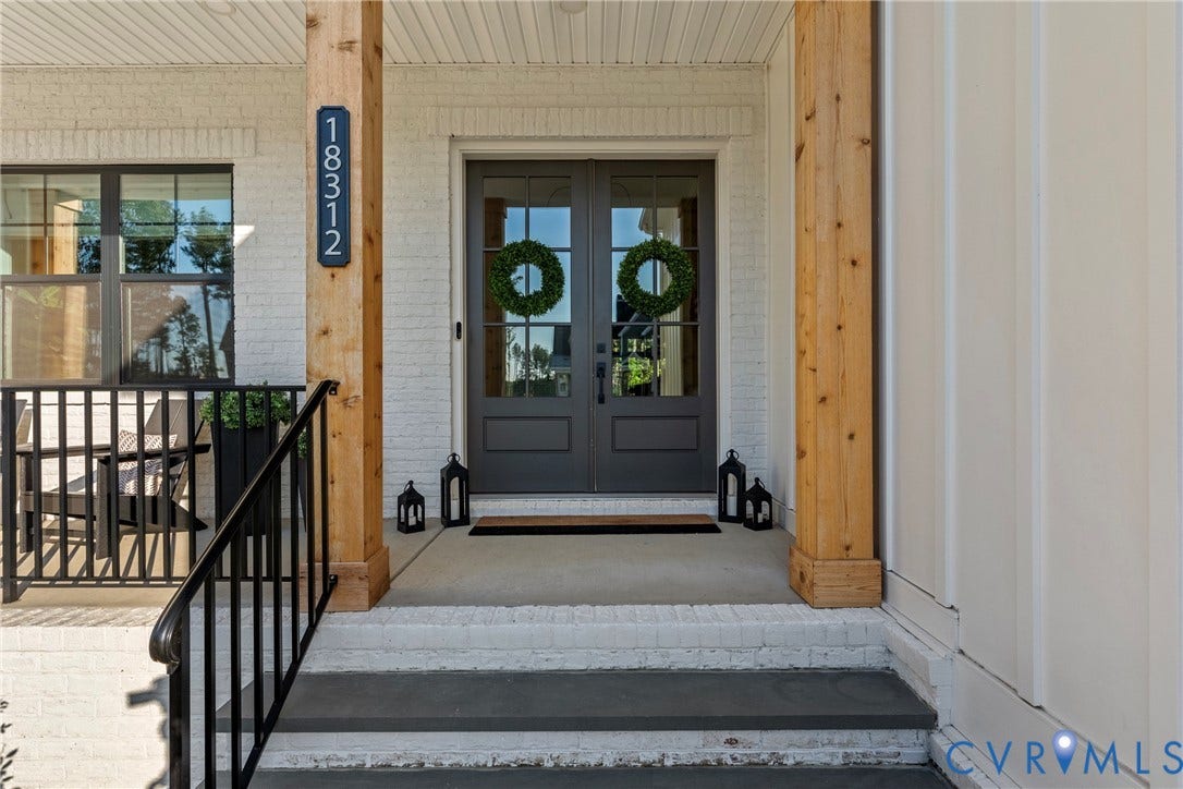 18312 Barrin Court, Barrington, Moseley, VA 23120 Inviting front porch featuring a white painted brick facade, natural wood columns, and a double-door entry with dark framing