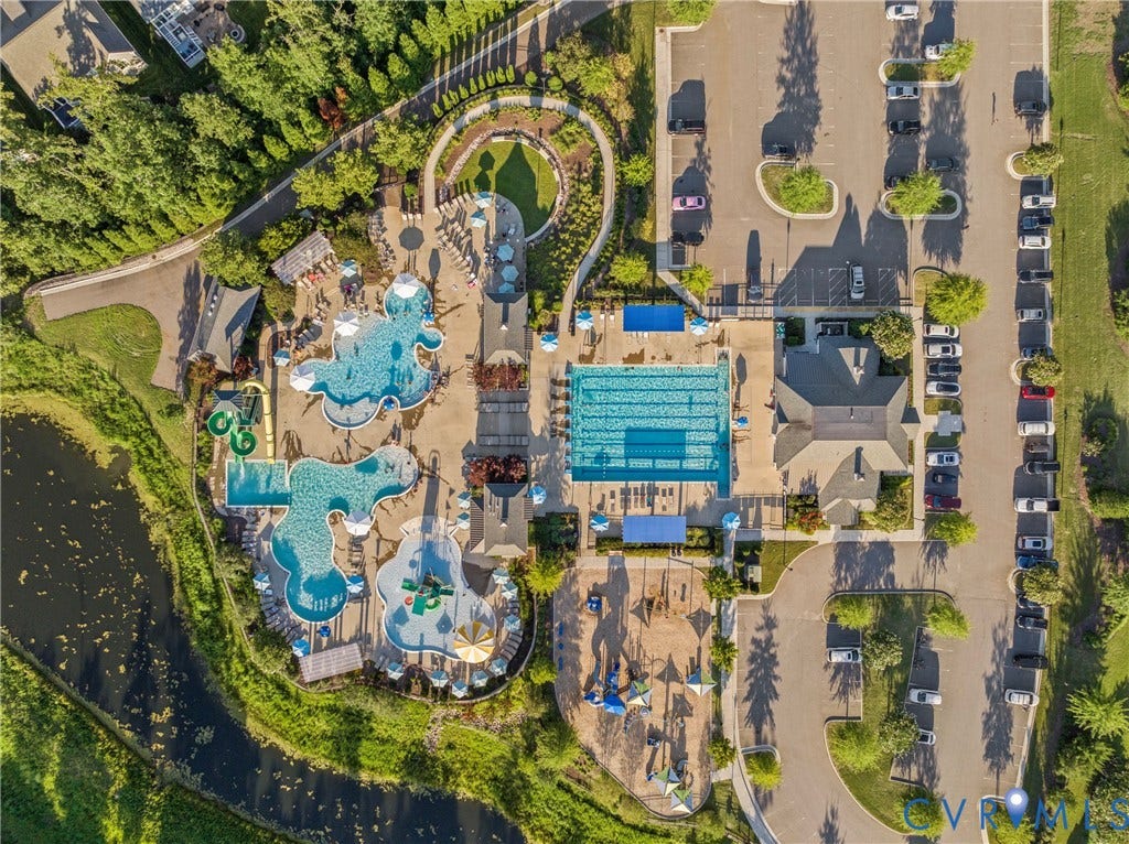 18312 Barrin Court, Barrington, Moseley, VA 23120 Aerial view showcasing an expansive aquatic facility featuring multiple swimming pools with varying shapes and depths, water slides, and designated play areas