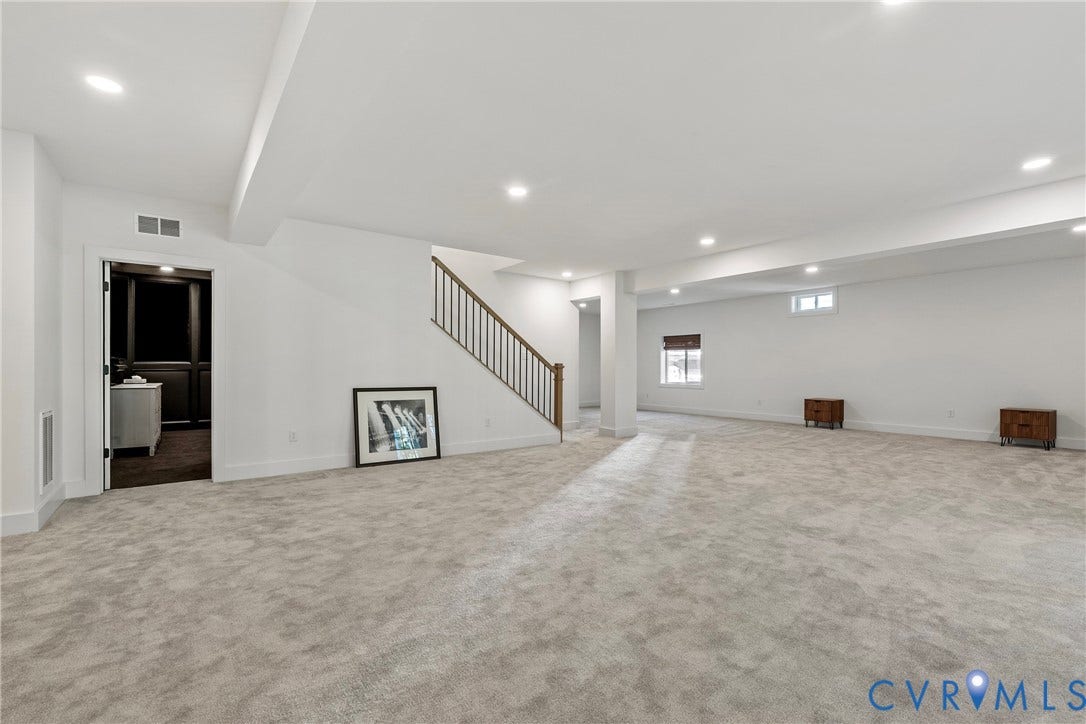 18312 Barrin Court, Barrington, Moseley, VA 23120 Spacious carpeted room featuring recessed lighting, a staircase with metal railings, and natural light from multiple windows