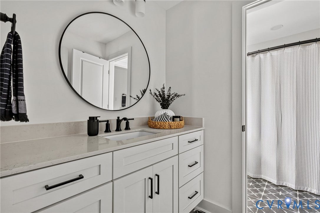 18312 Barrin Court, Barrington, Moseley, VA 23120 Bathroom vanity with a light-toned countertop, undermount sink, and matte black faucet