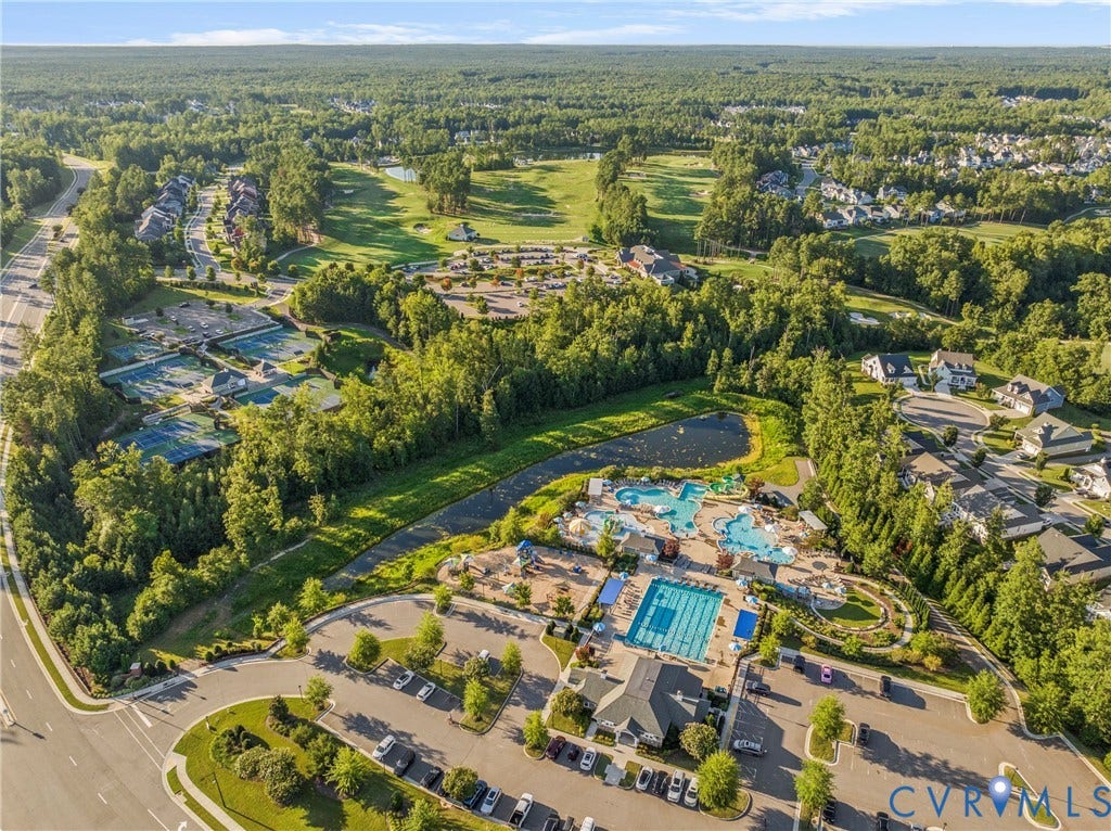 18312 Barrin Court, Barrington, Moseley, VA 23120 Aerial perspective of a community featuring a resort-style aquatic center with multiple pools, a clubhouse, and ample parking