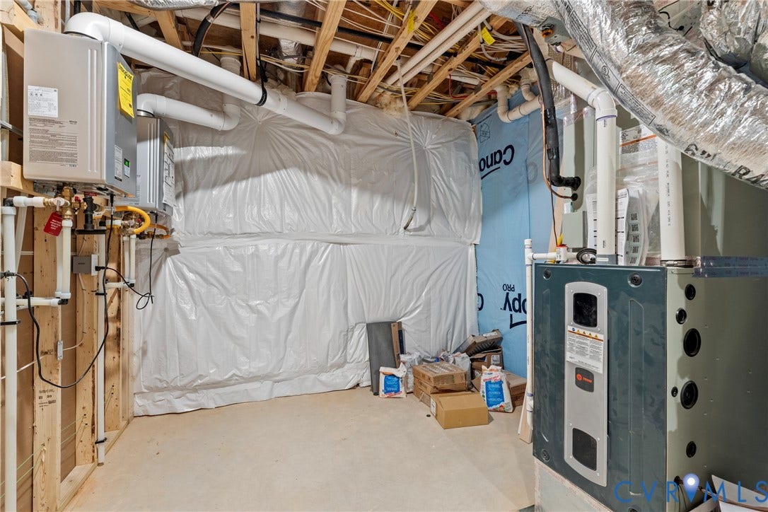18312 Barrin Court, Barrington, Moseley, VA 23120 Utility area featuring exposed wood framing, a tankless water heater, and a furnace unit
