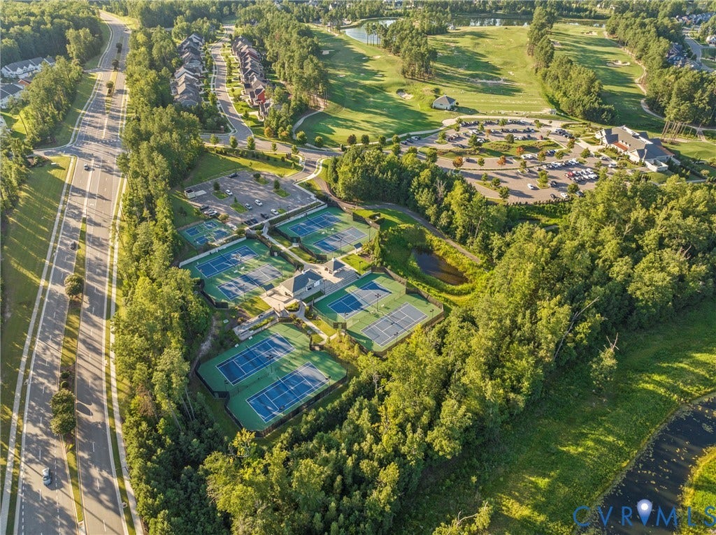 18312 Barrin Court, Barrington, Moseley, VA 23120 Aerial perspective showcasing multiple tennis courts, adjacent parking facilities, and surrounding wooded areas