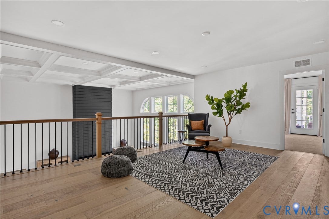 18312 Barrin Court, Barrington, Moseley, VA 23120 Spacious open loft area featuring wood-finish flooring, a coffered ceiling, and a prominent black shiplap architectural accent
