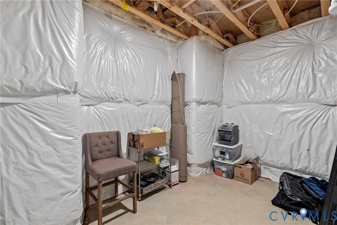 18312 Barrin Court, Barrington, Moseley, VA 23120 Unfinished basement area featuring exposed ceiling joists and insulated walls, presenting opportunity for future customization