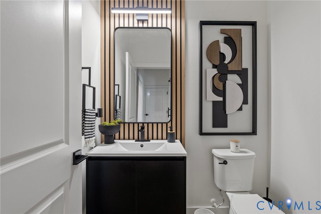 18312 Barrin Court, Barrington, Moseley, VA 23120 Modern bathroom featuring a black vanity with integrated sink, matte black faucet, and a rectangular framed mirror