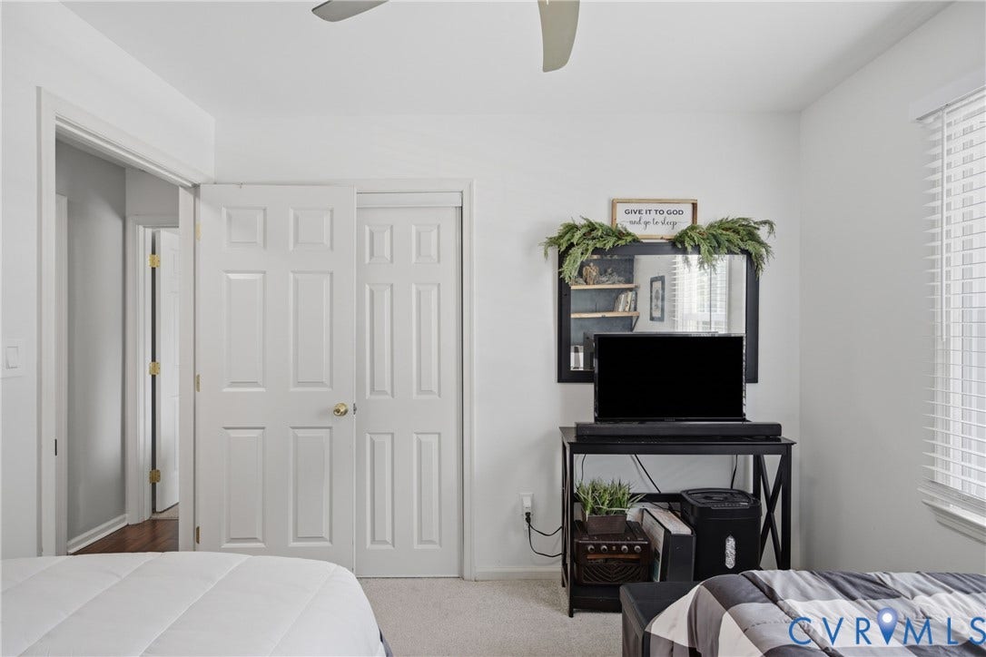 Interior room with neutral wall color, carpeted flooring, and a ceiling fan