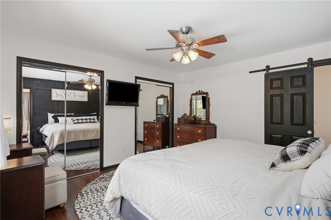Room featuring wood-finish flooring and a ceiling fan