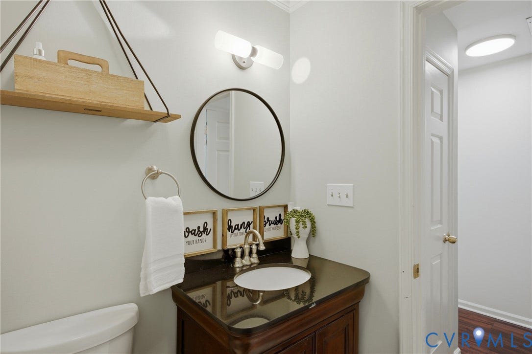 Bathroom vanity with a dark countertop and undermount sink