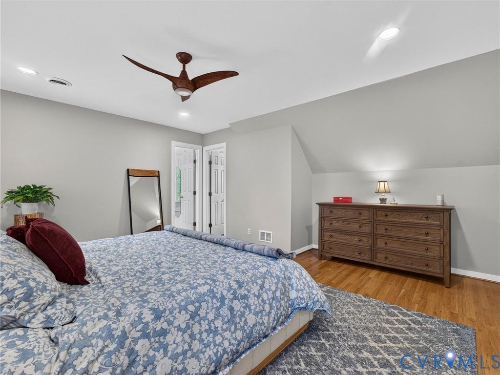 Recessed lighting, wood-finish flooring, a contemporary ceiling fan, and white bifold doors