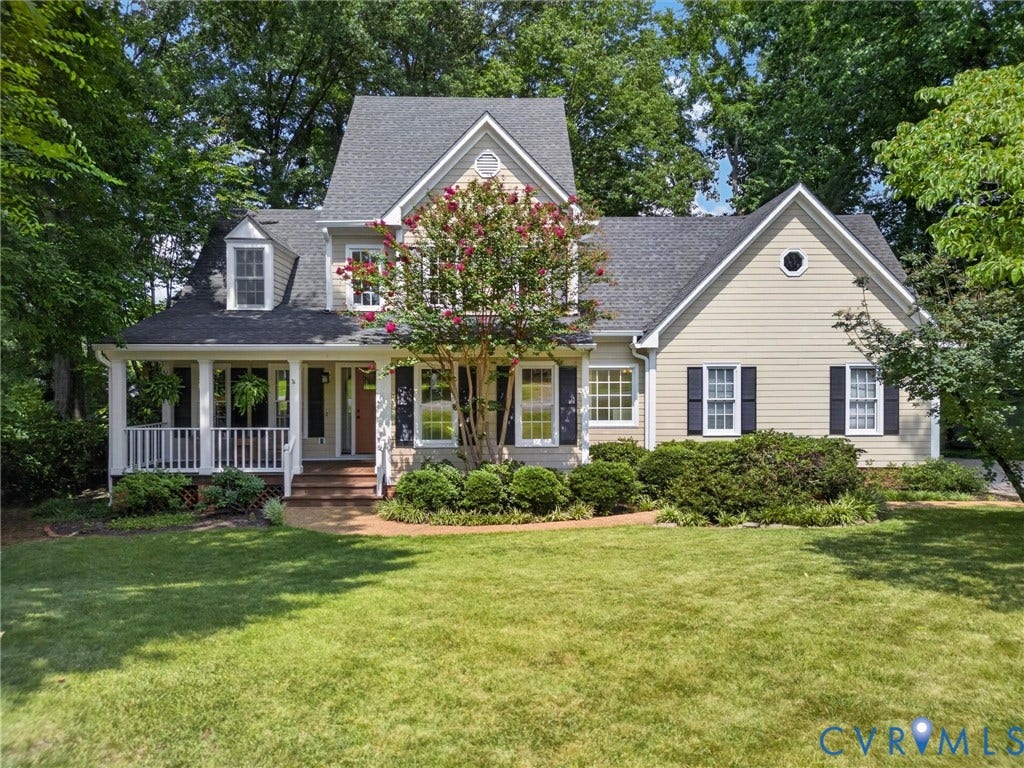 Traditional-style exterior with light-colored siding and dark shutters