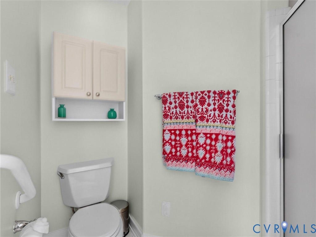 Wall-mounted cabinet with open shelving, toilet, and a glass-enclosed shower