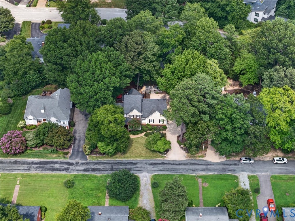 Waterfront Colonial residence nestled on a tree-lined lot with mature landscaping and established shade trees