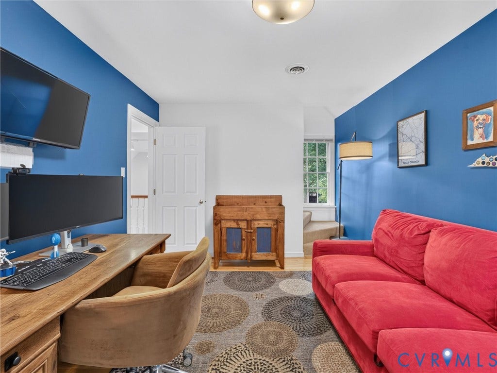 Recessed ceiling light fixture, wood-finish flooring, and white interior door