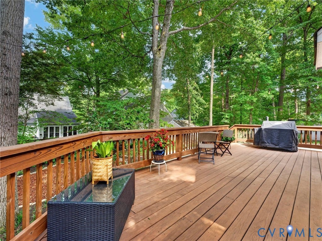 Expansive wood deck with natural wood railings, providing ample outdoor living space